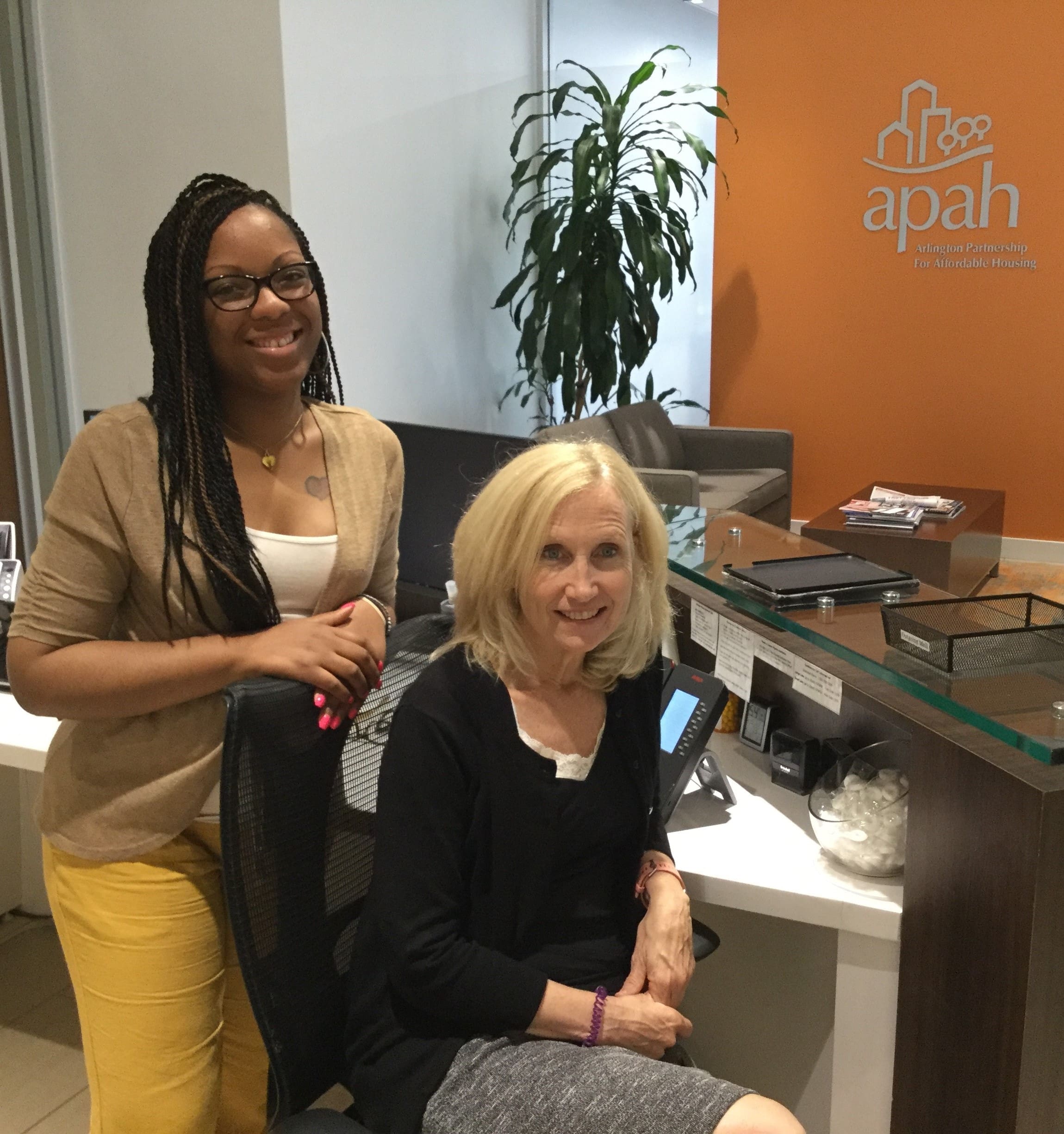 Smiling women working at Arlington Partnership for Affordable Housing.