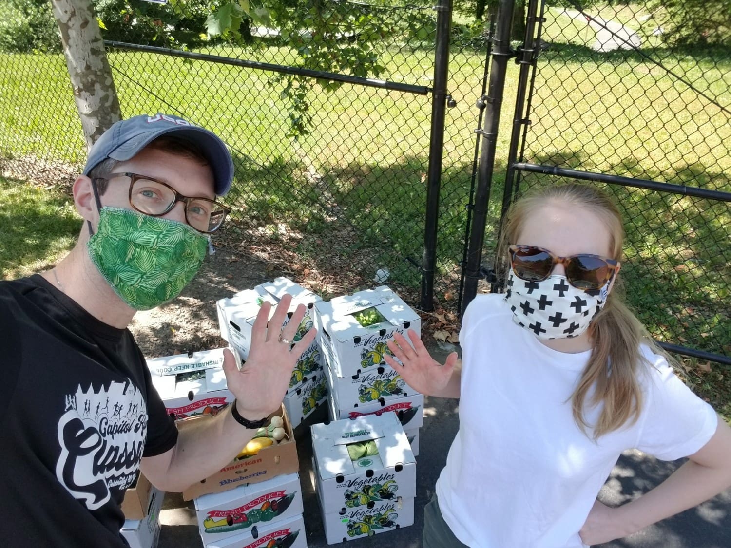 Martin and Natalia distributing produce boxes at Buchanan Gardens.